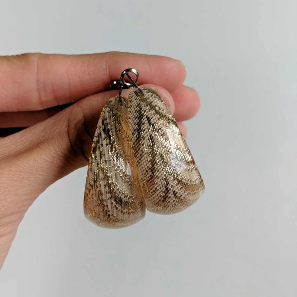 Gold patterned earrings.